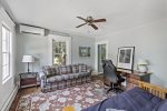 Den with futon, ceiling fan, mini spilt AC unit and desk